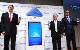 Softbank president Masayoshi Son (C), eBay CEO John Donahoe (L) and PayPal president David Marcus