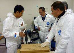 Takeshi Takahashi (L), chief of the stricken Fukushima Daiichi nuclear power plant, shows data to Eric Besson