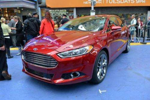 The 2013 Ford Fusion Hybrid at its introduction in New York's Times Square in September