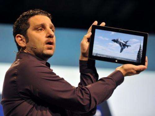 The general manager of the Microsoft Surface tablet holds up the product