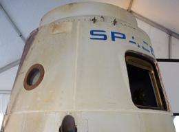 The SpaceX Dragon spacecraft, bearing brown and black scorch marks from its fiery tour in orbit, is pictured in 2011