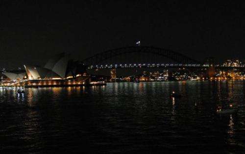 The Sydney Opera House and the Sydney Harbour Bridge are darkened at the start of the 6th annual Earth Hour