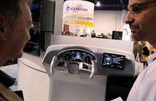 Visitors look at the Audi MMI 3G technology system, powered by Invidia, at CES in Las Vegas