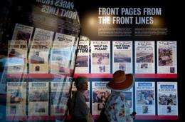 Visitors tour front pages from The Times-Picayune newspaper in New Orleans as part of an exhibit at the Newseum in 2010