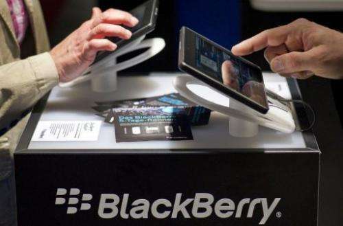 Visitors try out Blackberry tablet PC's at the CeBIT high-tech fair in Hanover