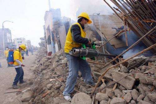 Volunteers dig through the rubble after an earthquake in Peru, which sits on the Nazca tectonic plate