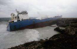 Waves break over an Italian oil tanker that ran aground