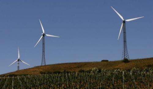 Wind turbines spin in a village between Palermo and Trapani in Italy