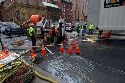 Work crews from Verizon pump water from an access tunnel in Lower Manhattan