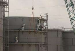 Workers construct water tanks at TEPCO's Fukushima Daiichi nuclear power plant