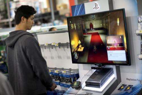 A customer is seen playing a game on Sony Playstation 4, on display at Best Buy store in Pembroke Pines, Florida, on November 15