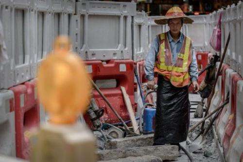 A labourer works at a roadworks site in Hong Kong on July 9, 2013