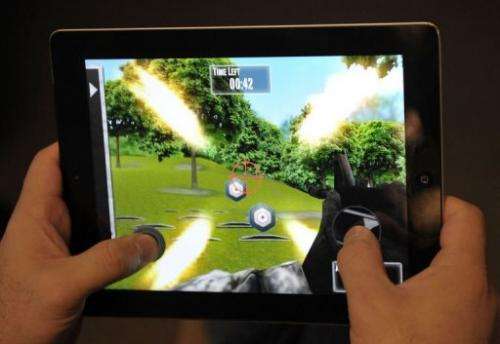 A man plays the newly released National Rifle Association (NRA) iPhone/iPad app, "NRA: Practice Range"