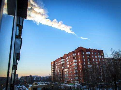 A meteorite trail is seen above a residential apartment block in the Russian city of Chelyabinsk on February 15, 2013