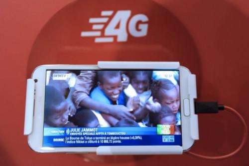 A mobile phone plays a video of BFM TV taken during the launch of the SFR 4G mobile network in Paris on January 29, 2013