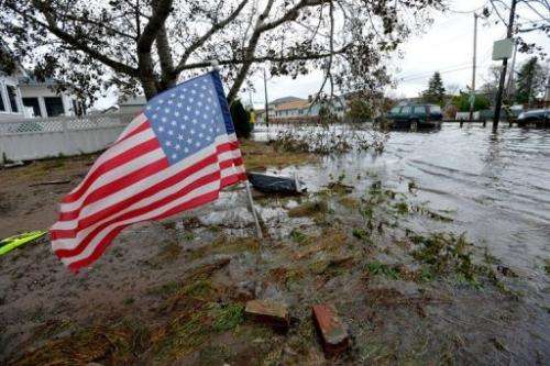 An American flag flies from the front yard of a house on October 30, 2012 in the Breezy Point area of Queens in New York