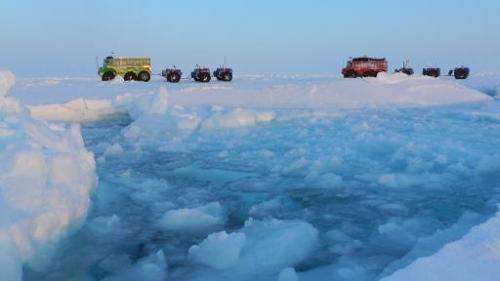 An undated image released by the Marine Ice Automobile Expedition shows expedition trucks crossing the North Pole