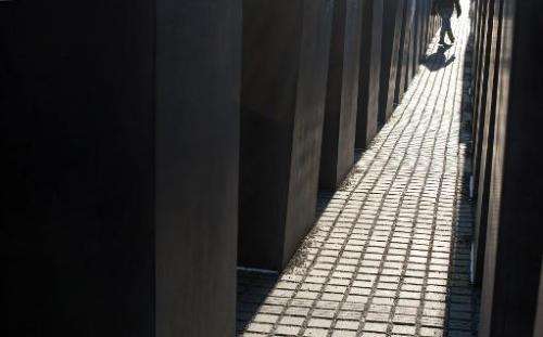 A person walks past concrete steles at the Holocaust Memorial in Berlin, on January 31, 2012