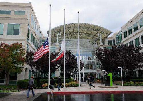 Apple employees arrive to work at the Apple headquarters on October 5, 2011 in Cupertino, California
