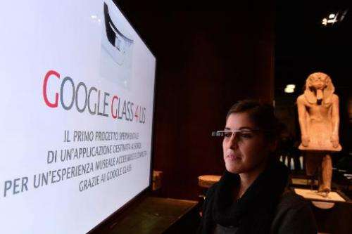 A woman tests a pair of Google glasses equiped with Italian Sign Language capabilities at the Egyptian Museum in Turin, on Novem