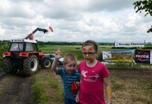 Children play near where oil company Chevron plans to put a shale gas drilling rig, Zurawlow, Poland, June 11, 2013