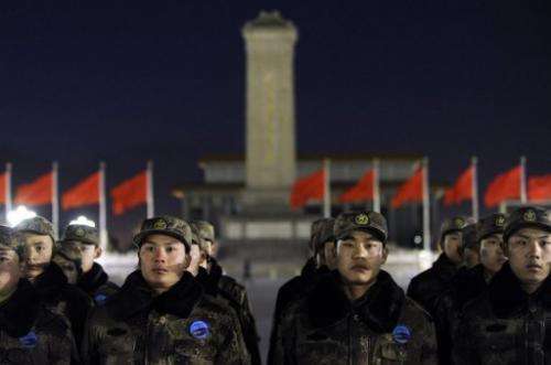 Chinese soldiers prepare to watch a flag-raising ceremony at Beijing's Tiananmen Square on January 1, 2013