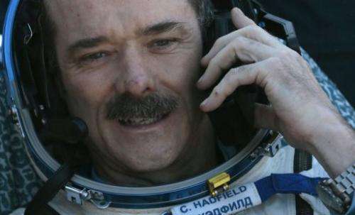 Chris Hadfield speaks on the phone shortly after landing in central Kazakhstan on May 14, 2013