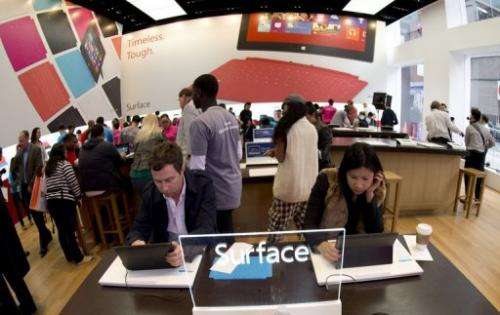 Customers get a look at products at Microsoft's pop-up store in Times Square, on October 26, 2012 in New York