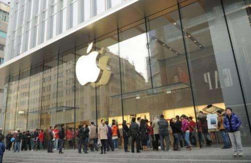 Customers wait for an Apple store to open in Shanghai on December 7, 2012