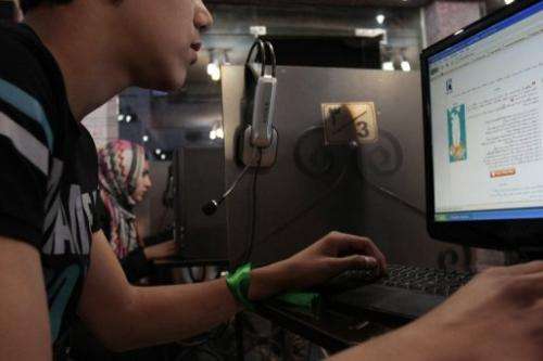 File photo shows an Iranian youth using a computer at an internet cafe in Iran's Hamadan province