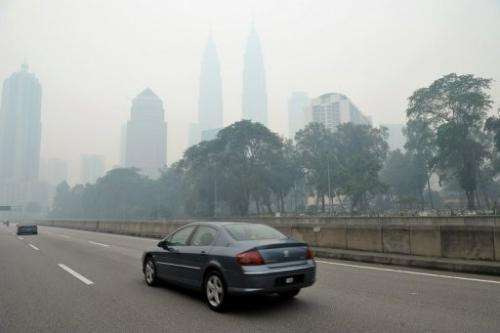 Haze shrouds Malaysia's Petronas Twin Towers in Kuala Lumpur on June 23, 2013