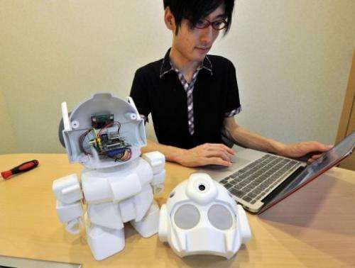 Japanese engineer Shota Ishiwatari displays the robot &quot;Rapiro&quot; which works with a &quot;Raspberry Pi&quot; in Tokyo, J