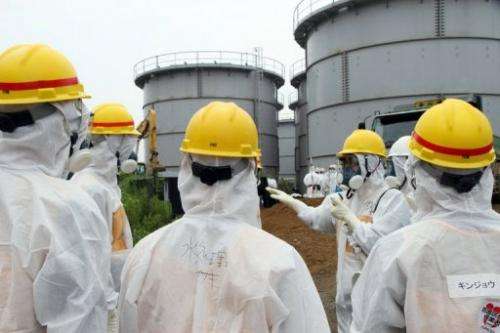 Japan's nuclear watchdog inspects contaminated water tanks at the Fukushima nuclear power plant on August 23, 2013