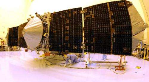 NASA's Mars Atmosphere and Volatile Evolution (MAVEN) spacecraft with solar panels extended is checked by technicians on Septemb