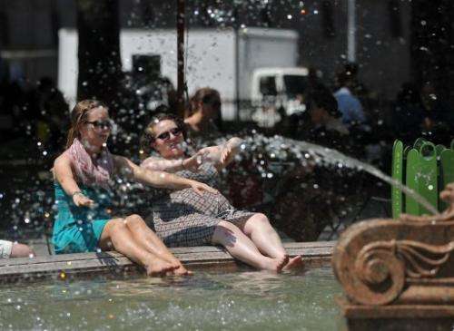 People cool off as they relax in a fountain in Bryant Park on May 30, 2013 in New York