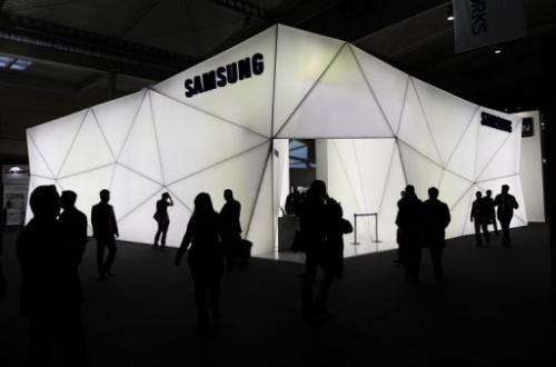 People visit the Samsung stand at the Mobile World congress in Barcelona on February 25, 2013