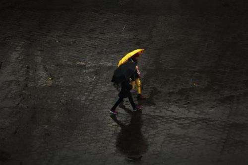 People walk in the rain through Union Square in Manhattan on November 26, 2013 in New York City