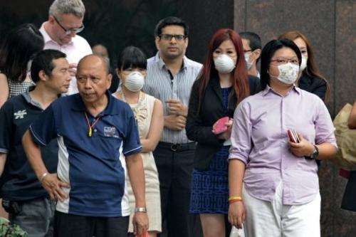 People wear face masks in Singapore on June 20, 2013