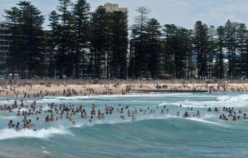 Sydneysiders and tourists cool off as they swim in the sea at Manly beach in Sydney on January 8, 2013