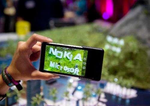 The European Commission approved on Wednesday Microsoft's nearly 5.5-billion-euro takeover of the mobile phone business of Finla