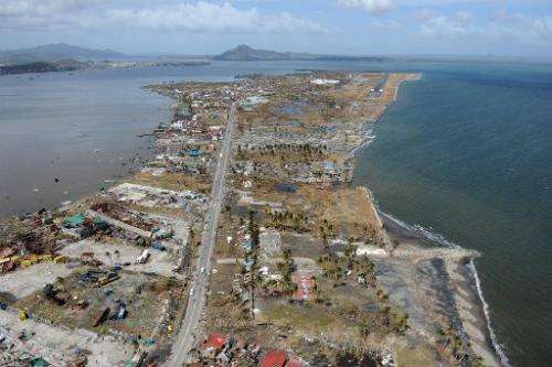 This aerial photo shows destroyed houses and the airport terminal (upper R) in the city of Tacloban, Leyte province, in the cent
