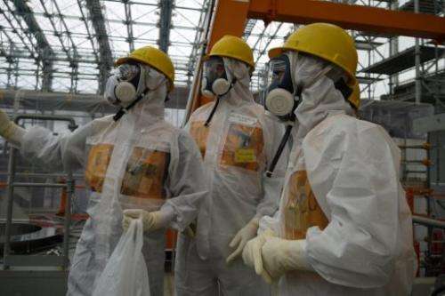 Workers inspect the Fukushima Dai-ichi nuclear power plant on September 12, 2013