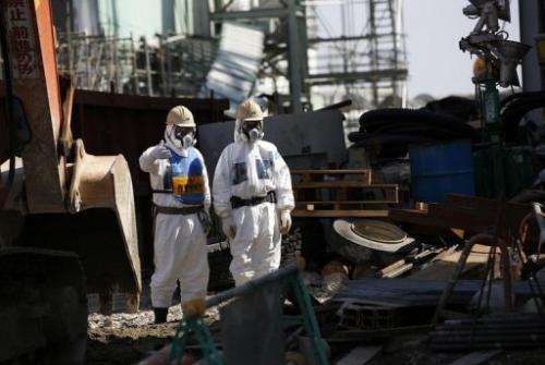 Workers wearing protective clothing at the Fukushima nuclear power plant on March 6, 2013