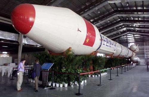 Image taken on November 3, 2002 shows visitors next to a Long March 3-B rocket at the Zhuhai Air Show
