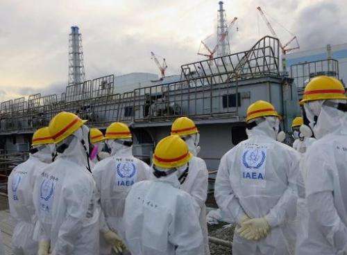 Members of the International Atomic Energy Agency inspecting a spent fuel pool at the crippled Tokyo Electric Power Fukushima Da