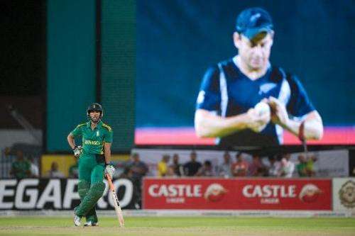 This file photo shows South Africa's Farhaan Berhardien (L) waiting while New Zealand's skipper Brendon McCullum is seen on the 