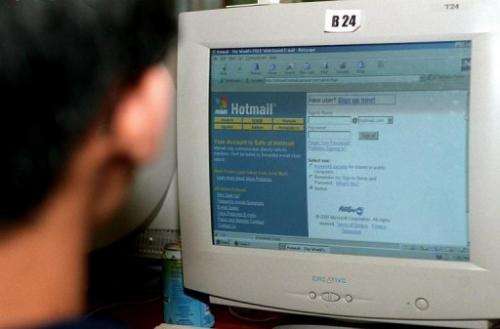 A man checks his Hotmail e-mail account at a cyber cafe in Singapore on September 21, 2000