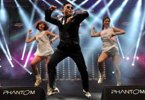 South Korean singer Psy (L) performs his hit single &quot;Gangnam Style&quot; during a concert in Istanbul on February 22, 2013