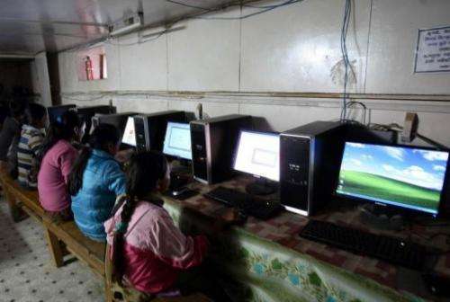This photo taken on October 25, 2010 shows Nepalese girls surfing the internet in the village of Nagi