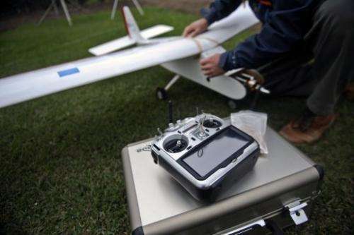 A man prepares a drone before its launch in Lima, Peru on July 10, 2013